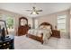 Warm bedroom features ceiling fan, tile floors, and traditional furnishings at 301 Wingdale Way, Davenport, FL 33897