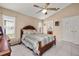 Comfortable bedroom features a ceiling fan and neutral-colored walls at 301 Wingdale Way, Davenport, FL 33897