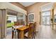 Formal dining room features wooden table and chairs with sliding glass doors to the backyard at 301 Wingdale Way, Davenport, FL 33897