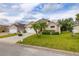 Charming home featuring a well-manicured lawn, lush landscaping, and a welcoming curb appeal at 301 Wingdale Way, Davenport, FL 33897