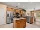 Modern kitchen with stainless steel appliances, granite countertops, and a center island at 301 Wingdale Way, Davenport, FL 33897