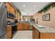 Well-equipped kitchen featuring granite countertops, stainless steel appliances, and ample storage at 301 Wingdale Way, Davenport, FL 33897