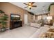 Inviting living room with tile flooring, a ceiling fan, and a view of the backyard at 301 Wingdale Way, Davenport, FL 33897