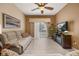 Bright living room featuring tile floors, comfortable seating, and sliding glass doors to the patio at 301 Wingdale Way, Davenport, FL 33897
