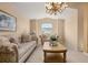 Living room with decorative chandelier, comfortable seating, and natural light at 301 Wingdale Way, Davenport, FL 33897