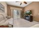 Comfortable living room with plush seating, entertainment center, and a ceiling fan at 301 Wingdale Way, Davenport, FL 33897