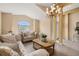 Bright living room with chandelier, cozy seating, and view of the foyer at 301 Wingdale Way, Davenport, FL 33897