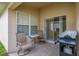 Outdoor patio with table, chairs, and BBQ grill for entertaining at 301 Wingdale Way, Davenport, FL 33897