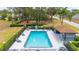Community pool featuring a large swimming area, lounge chairs, and a shaded seating area perfect for relaxation at 301 Wingdale Way, Davenport, FL 33897