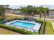 Community pool surrounded by well-maintained landscaping and a sun deck, offering a refreshing amenity for residents at 301 Wingdale Way, Davenport, FL 33897