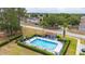 Aerial view of the community pool, showcasing the clean design, landscaping, and proximity to neighborhood homes at 301 Wingdale Way, Davenport, FL 33897