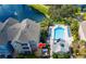 Aerial view of a lakeside condo community with a swimming pool and lush landscaping at 3344 Corona Village Way # 207, Orlando, FL 32835