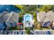 Aerial view of condo building showcasing in-ground community pool with sundeck and lake views at 3344 Corona Village Way # 207, Orlando, FL 32835