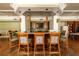 Clubhouse bar featuring wooden barstools with pineapple design, wooden floors, and a television at 3344 Corona Village Way # 207, Orlando, FL 32835
