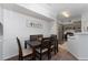 Cozy dining area featuring a dark wood table and chairs next to the modern kitchen at 3344 Corona Village Way # 207, Orlando, FL 32835