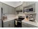 Charming kitchen with stainless steel appliances and updated cabinetry, great for cooking at 3344 Corona Village Way # 207, Orlando, FL 32835
