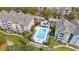 Aerial view of a sparkling pool with lounge chairs and meticulously manicured landscaping at 3344 Corona Village Way # 207, Orlando, FL 32835