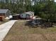 Wide aerial view of a single-story home with fire pit and landscaped yard at 3669 General Marshall Rd, Daytona Beach, FL 32124