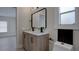 Bathroom with new double vanity, modern fixtures, and light gray tile floors at 3669 General Marshall Rd, Daytona Beach, FL 32124