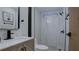 Modern bathroom with white marble countertop, patterned wood cabinets, and stylish tiled shower at 3669 General Marshall Rd, Daytona Beach, FL 32124