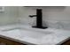 This bathroom features a marble countertop, modern black faucet and rectangular sink at 3669 General Marshall Rd, Daytona Beach, FL 32124