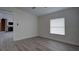 Large bedroom with view to the living room, with a fireplace, and a large window at 3669 General Marshall Rd, Daytona Beach, FL 32124