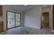Dining area with sliding glass doors to the back deck and new light colored wood floors at 3669 General Marshall Rd, Daytona Beach, FL 32124