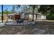 Lovely exterior of the home with a wood and stone fire pit at 3669 General Marshall Rd, Daytona Beach, FL 32124