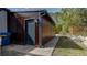 Side exterior view of the house featuring a private entrance and dark painted trim at 3669 General Marshall Rd, Daytona Beach, FL 32124