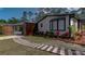 Charming single-story home with a stone and wood path, vibrant landscaping, and a detached garage at 3669 General Marshall Rd, Daytona Beach, FL 32124