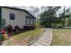 Well-manicured front yard with beautiful landscaping, hardscaping, and charming walkway at 3669 General Marshall Rd, Daytona Beach, FL 32124