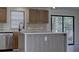 Bright kitchen featuring a stylish island, stainless steel appliances, and decorative backsplash at 3669 General Marshall Rd, Daytona Beach, FL 32124
