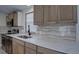 Close up of the kitchen featuring stainless steel appliances, quartz countertops, and modern fixtures at 3669 General Marshall Rd, Daytona Beach, FL 32124