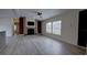 Open living room with modern floors, brick fireplace, and plenty of natural light at 3669 General Marshall Rd, Daytona Beach, FL 32124