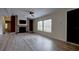 Open living room with modern light floors, brick fireplace, and plenty of natural light at 3669 General Marshall Rd, Daytona Beach, FL 32124