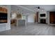 Beautiful open living space showcasing modern wood floors, a stone fireplace, and a stylish kitchen at 3669 General Marshall Rd, Daytona Beach, FL 32124