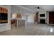 Open-concept living space with modern wood floors, a stone fireplace, and a stylish kitchen at 3669 General Marshall Rd, Daytona Beach, FL 32124