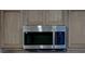 New stainless steel microwave above electric stove with wood cabinets at 3669 General Marshall Rd, Daytona Beach, FL 32124