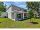 The covered patio overlooks a large backyard with freshly cut grass and mature trees at 3773 Deer Ridge Dr, Mount Dora, FL 32757