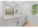 Bright bathroom with double sinks and a large mirror above the vanity at 3773 Deer Ridge Dr, Mount Dora, FL 32757