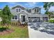 Charming two-story home with a three-car garage, well-manicured lawn, and welcoming entryway at 3773 Deer Ridge Dr, Mount Dora, FL 32757