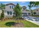 Beautiful two-story home with a three-car garage, landscaped front yard, and stone accents at 3773 Deer Ridge Dr, Mount Dora, FL 32757
