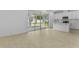 Open-concept living room with tile floors, sliding glass doors to the backyard, and a breakfast bar at 3773 Deer Ridge Dr, Mount Dora, FL 32757