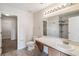 Well-lit bathroom featuring a large vanity, ample counter space, and a walk-in shower with tiled walls at 410 Canna Dr, Davenport, FL 33897