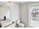 Modern bathroom with stylish floating vanity, sleek fixtures, and a door leading to the pool area at 410 Canna Dr, Davenport, FL 33897