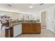 Kitchen with wooden cabinets, granite countertops, tile flooring and stainless sink at 410 Canna Dr, Davenport, FL 33897