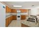 Well-lit kitchen with granite countertops, tiled floors and ample cabinet space at 410 Canna Dr, Davenport, FL 33897