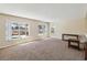 Spacious living room features neutral walls, carpet and multiple bright windows at 410 Canna Dr, Davenport, FL 33897