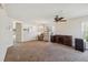 Spacious living room features neutral walls, carpet and a modern ceiling fan at 410 Canna Dr, Davenport, FL 33897
