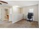 Open loft area showcasing carpet flooring, a desk, and a view into an adjacent bathroom at 410 Canna Dr, Davenport, FL 33897